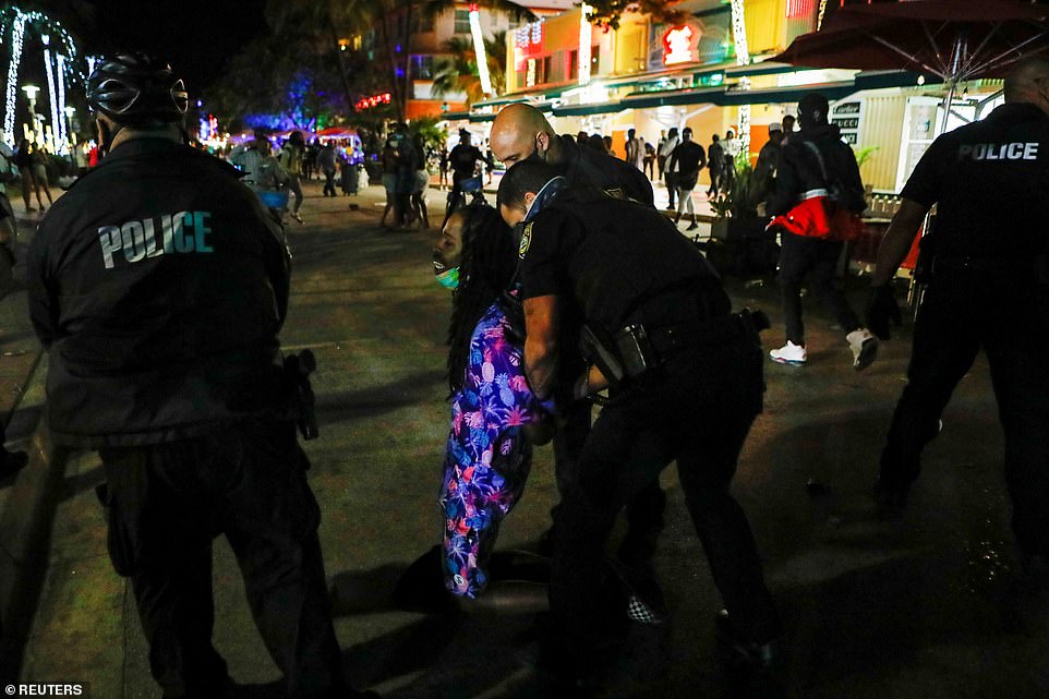 Police officers have arrested at least 1,000 people in South Beach and SWAT teams have been called in to use pepper balls to break up crowds of partiers