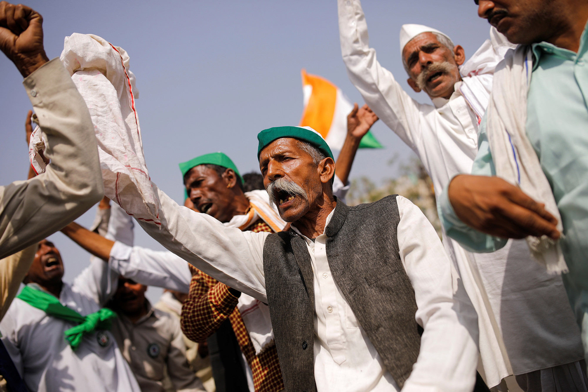 Farmers dance as they sing a folk song during a 12-hour strike, as part of protests against farm laws, on a highway at the Delhi-Uttar Pradesh border in Ghaziabad, India, March 26, 2021.